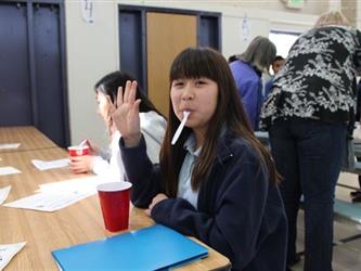 A student with a spoon waving